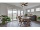 Inviting dining area with wood floors, sliding glass doors to patio, and an elegant ceiling fan at 349 Long Pier St, Summerville, SC 29486