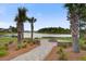 Picturesque community fire pit near a serene lake and swaying palm trees. A perfect spot for relaxation at 349 Long Pier St, Summerville, SC 29486
