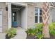 Welcoming front entrance with a teal door, brick accents, lush landscaping, and a paved walkway at 349 Long Pier St, Summerville, SC 29486