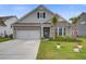 Beautiful two-story home featuring a blend of brick and siding, complemented by lush landscaping and a well-kept lawn at 349 Long Pier St, Summerville, SC 29486