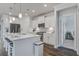 Bright, modern kitchen features white cabinetry, stainless steel appliances, and a large island with seating at 349 Long Pier St, Summerville, SC 29486