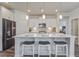 Modern kitchen with white cabinets, stainless steel appliances, a granite island, and bar stool seating at 349 Long Pier St, Summerville, SC 29486