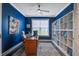Stylish home office with blue walls, custom bookshelves, modern lighting, and a comfortable desk setup at 349 Long Pier St, Summerville, SC 29486