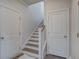 View of staircase with hardwood treads and white risers, flanked by doors, leading to the upper level at 349 Long Pier St, Summerville, SC 29486