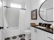 Bathroom featuring modern fixtures, patterned tile flooring, shower and vanity with a dark countertop at 4 Addison St, Charleston, SC 29403