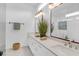 Elegant bathroom features dual sinks, white cabinetry, and large mirrors, providing ample space at 4 Addison St, Charleston, SC 29403