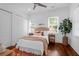 Comfortable bedroom with two windows, overhead fan and a bed with neutral colored linens and pillows at 4 Addison St, Charleston, SC 29403