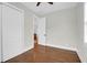 Cozy bedroom with hardwood floors and ample natural light, featuring a closet and doorway to another room at 4 Addison St, Charleston, SC 29403