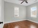 Spacious bedroom with hardwood floors and two large windows, perfect for a relaxing retreat at 4 Addison St, Charleston, SC 29403