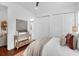 Bedroom with closet and decorative furnishings, featuring upholstered headboard, modern lighting, and hardwood floors at 4 Addison St, Charleston, SC 29403