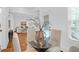 Cozy dining space with stylish glass table, four chairs, hardwood floors, and natural light at 4 Addison St, Charleston, SC 29403