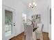 Cozy dining area with a glass table, four chairs, chandelier and natural lighting from the windows at 4 Addison St, Charleston, SC 29403