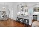 Modern kitchen with sleek white cabinetry, stainless steel appliances and a breakfast bar with seating at 4 Addison St, Charleston, SC 29403