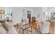 Bright living room featuring hardwood floors, white walls, modern decor and a view into the dining room at 4 Addison St, Charleston, SC 29403
