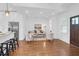 Bright open concept living space featuring hardwood floors, modern decor, an open kitchen and stainless steel appliances at 4 Addison St, Charleston, SC 29403