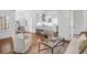 Sun-filled open concept living space featuring hardwood floors, modern decor and a breakfast bar with seating at 4 Addison St, Charleston, SC 29403