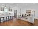Bright and airy living room featuring hardwood floors, white walls and modern furnishings and an open-concept kitchen at 4 Addison St, Charleston, SC 29403