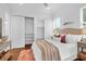 Bedroom with closet and decorative furnishings, featuring an upholstered headboard and modern lighting at 4 Addison St, Charleston, SC 29403