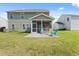 Exterior of the two-story home with a screened porch and a well-maintained backyard at 433 Thoroughbred Dr, Moncks Corner, SC 29461