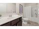 This is a bathroom with a dark brown vanity, a white sink, a toilet, and a bathtub with a white curtain at 433 Thoroughbred Dr, Moncks Corner, SC 29461