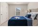 This is a bedroom with a bed with blue covers, a lamp, and a circular piece of art on the wall at 433 Thoroughbred Dr, Moncks Corner, SC 29461