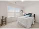 This bright bedroom features a cozy bed, side table, and two windows with lots of natural light at 433 Thoroughbred Dr, Moncks Corner, SC 29461