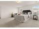 Bright bedroom featuring a large bed, side tables, and a comfortable sitting area by the windows at 433 Thoroughbred Dr, Moncks Corner, SC 29461