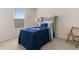 This cozy bedroom boasts a comfortable bed with blue covers and a small chair in a well-lit space at 433 Thoroughbred Dr, Moncks Corner, SC 29461