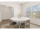 A bright dining area is shown with a white round table and seating for four at 433 Thoroughbred Dr, Moncks Corner, SC 29461