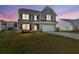 Charming two-story home features a manicured lawn, brick accents, and a two-car garage at 433 Thoroughbred Dr, Moncks Corner, SC 29461