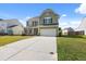 Charming two-story home with a well-manicured lawn and a spacious driveway at 433 Thoroughbred Dr, Moncks Corner, SC 29461