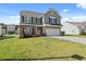 Charming two-story home with a well-manicured lawn and a spacious driveway at 433 Thoroughbred Dr, Moncks Corner, SC 29461