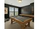 This is a bright game room with a pool table and shuffleboard table that is great for entertaining guests at 433 Thoroughbred Dr, Moncks Corner, SC 29461