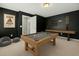 Spacious game room with a billiard table, shuffleboard, and comfortable seating at 433 Thoroughbred Dr, Moncks Corner, SC 29461