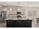 Modern kitchen with a large center island, granite countertops, and stainless steel appliances at 433 Thoroughbred Dr, Moncks Corner, SC 29461