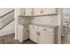 Kitchen area with white cabinets, stone counters and a staircase nearby at 433 Thoroughbred Dr, Moncks Corner, SC 29461