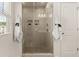 Tiled shower with glass doors and a built-in bench, complete with luxurious towel hangers at 433 Thoroughbred Dr, Moncks Corner, SC 29461