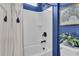 The bathroom features a white shower and modern matte black hardware with blue accent wall and decor at 440 Four Seasons Blvd, Summerville, SC 29486