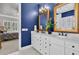 Bathroom features a white double sink vanity, gold framed mirrors, with blue walls and tile floors at 440 Four Seasons Blvd, Summerville, SC 29486