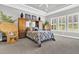 Spacious bedroom with a tray ceiling, and ample natural light from the surrounding windows at 440 Four Seasons Blvd, Summerville, SC 29486