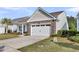 Charming home exterior with stone accents, well-maintained landscaping, and a paved driveway at 440 Four Seasons Blvd, Summerville, SC 29486