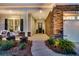 Charming front entrance with stone accents, manicured landscaping, and an inviting porch with rocking chairs at 440 Four Seasons Blvd, Summerville, SC 29486