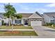 Charming single-Gathering home with stone accents, a well-maintained lawn, and a two-car garage at 440 Four Seasons Blvd, Summerville, SC 29486