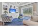 Bright living room featuring a stylish blue rug, comfortable seating, and sliding glass doors to the backyard at 440 Four Seasons Blvd, Summerville, SC 29486