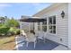 Outdoor patio with seating under an umbrella, perfect for relaxing or entertaining at 440 Four Seasons Blvd, Summerville, SC 29486