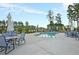 Community pool featuring ample seating and shaded tables under a sunny blue sky at 440 Four Seasons Blvd, Summerville, SC 29486