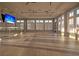 Bright studio space with wood floor, ceiling fans, wall mirror, and large windows that provide an abundance of natural light at 440 Four Seasons Blvd, Summerville, SC 29486
