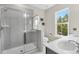 Modern bathroom with sleek glass shower, double sinks, and bright lighting for a refreshing experience at 4429 Avery Ave, North Charleston, SC 29405