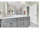 Clean bathroom featuring double vanity with gray cabinetry, gold hardware, and a walk-in shower with glass door at 4429 Avery Ave, North Charleston, SC 29405