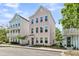 Charming three-story home with a pastel pink exterior and manicured front yard with healthy lawn at 4429 Avery Ave, North Charleston, SC 29405
